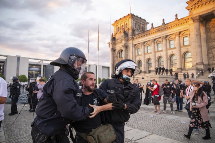 Police officers push away a crowd of demonstrators from the square ‘Platz der Republik’ in front of the Reichstag building during a demonstration against the Corona measures in Berlin, Germany, Saturday, 29 August, 2020.