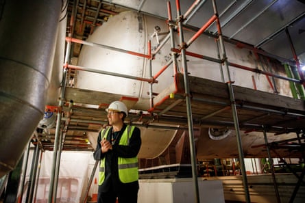 Richard McQuilliam stands in front of tanks