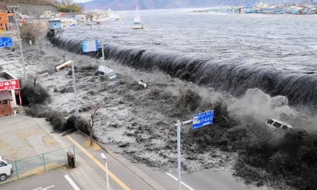 Seawater floods over a breakwater and on to a road