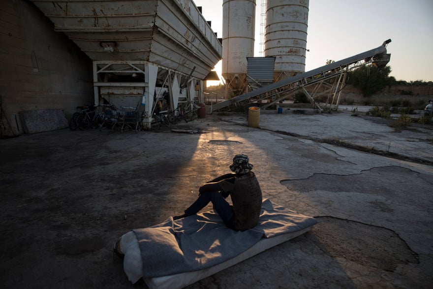 Migrant labourers at an abandoned cement factory in Sicily.