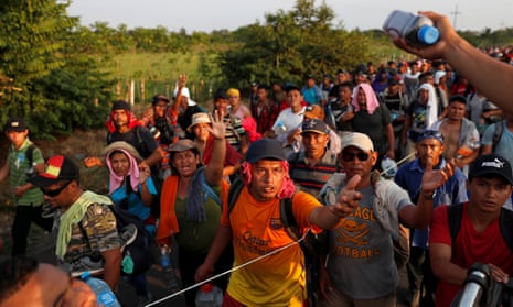 Migrants receive supplies while walking by the road that links Ciudad Hidalgo with Tapachula, Mexico on 2 November. 