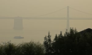 A ferryboat and the San Francisco-Oakland Bay Bridge are obscured due to smoke and haze from wildfires. 3000.jpg?width=300&quality=85&auto=forma