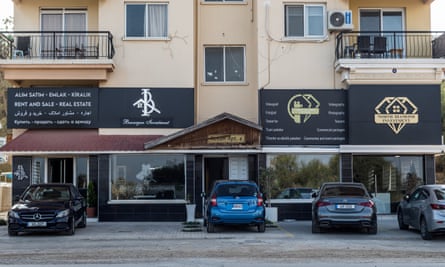 Investment companies are seen on the ground floor of a building with Arabic and Russian signs, in Famagusta, Northern Cyprus