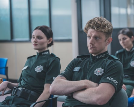 Two police officers sitting in office