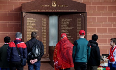 Fans look at a memorial to the victims of the Hillsborough disaster outside Anfield stadium in Liverpool last year