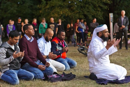 Mufti Zeeyad Ravat (R), a muslim leader from Melbourne, leads a prayer at the Deans Ave memorial, near Al Noor mosque in Christchurch, New Zealand on March 19, 2019.
