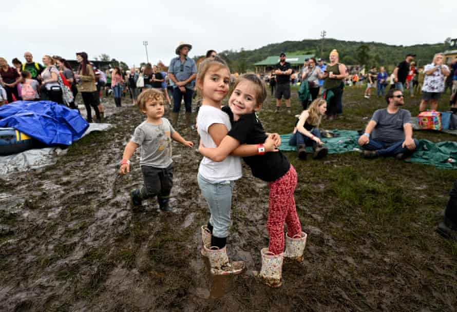 Savannah Foraita (L) and her friend Sasha Waters hug during the One From The Heart benefit concert on May 15, 2022 in Lismore, Australia.