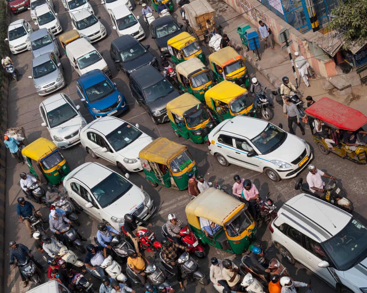 Traffic congestion in Delhi, India with cars and motorcycles jammed together