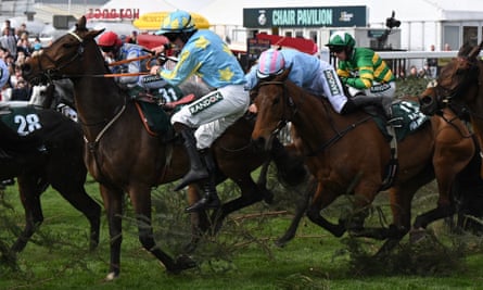 Brian Hayes (blue and pink colours is unseated from Mr Incredible after clearing The Chair in the Grand National at Aintree.