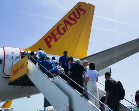 Passengers are boarding Pegasus airplane.