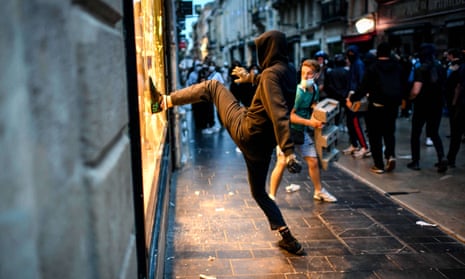 Protesters destroy the window of a shoe shop in Bordeaux.