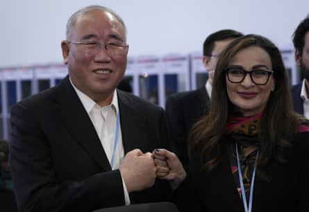 Xie Zhenhua, China's special envoy for climate, left, and Sherry Rehman, minister of climate change for Pakistan, pose for photos near the end of the summit.
