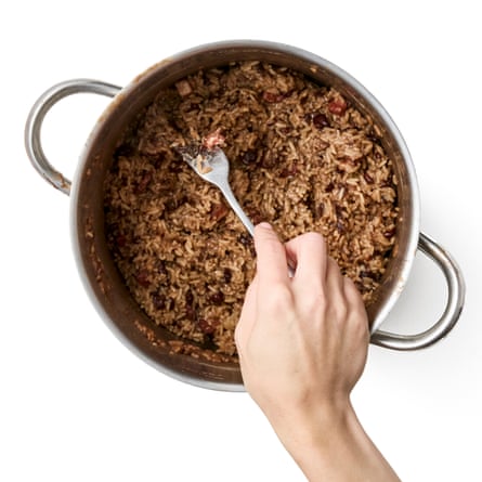 fluffing the rice with a fork