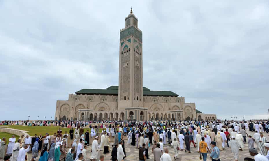Muslims are gathering to perform Eid al-Fitr prayer at Hassan II Mosque in Casablanca, Morocco.