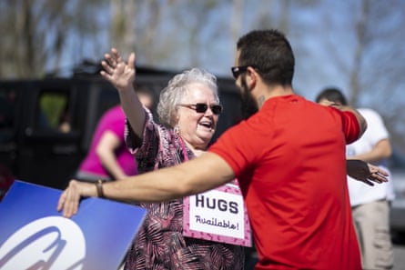 Billy Kennedy offers hugs to parishioners at a parking lot church service on 29 March in Mount Juliet, Tennessee.