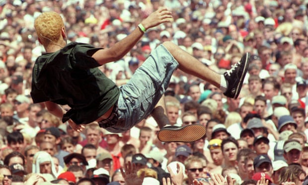 Crowd-surfing USA … a concertgoer at the Woodstock music and arts festival in 1999.