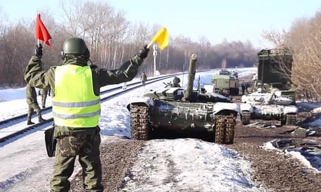 Russian army tanks are seen in a video provided by the Russian Defense Ministry being loaded onto railway platforms.