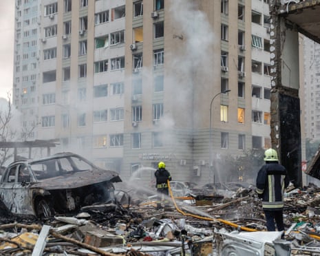 Ukrainian rescuers work at the site of a Russian missile strike on a residential area in Kyiv, Ukraine.