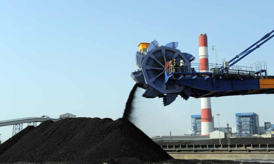 Indian workers use heavy machinery to sift through coal at the Adani Power company thermal power plant at Mundra, 400kms from Ahmedabad. The Indian firm wants to develop a giant coal mine in Queensland to feed its power plants. 