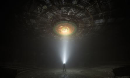 A figure is enveloped in a beam of light from beneath the Buzludzha monument, which is photographed to look like the underside of a UAP (unidentified flying phenomenon).