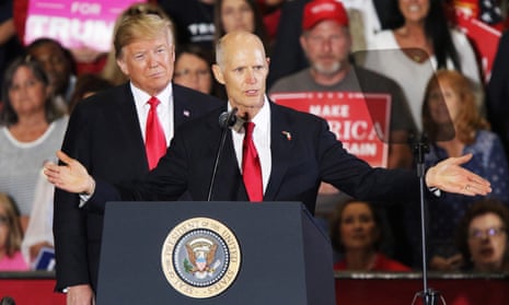 Rick Scott with Donald Trump at a rally in Florida in November last year. For Scott, a former healthcare executive worth $230m, refusing federal money was a bedrock principle.