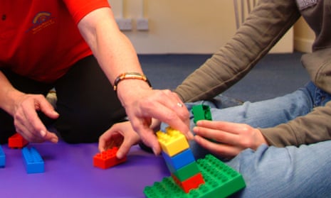 A playworker supports a child with special needs.