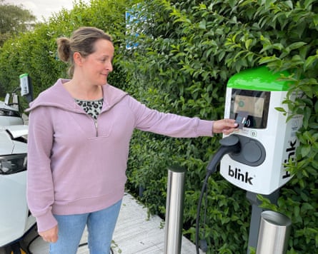Woman paying by card at an electric vehicle charger