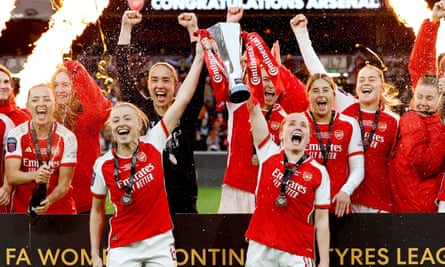 Arsenal's Leah Williamson and Kim Little lift the trophy as they celebrate after the 1-0 win over Chelsea.