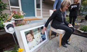 Tima Kurdi, touches a photo of her nephews Alan (left) and Ghalib Kurdi while speaking to the media outside her home in British Columbia.