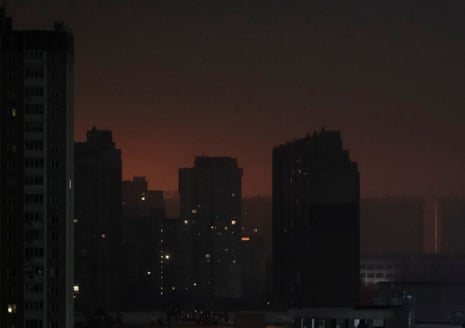 Nearly 300,000 people in Ukrainian city of Odesa without power or water after Russian drone strikes - Europe live | Ukraine 2 An explosion illuminates the night sky over Kiev and dark buildings appear in the foreground.