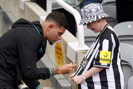 Newcastle United v Brentford: Premier League – live | Premier League 8 Bruno Guimaraes signs a fans shirt at St James’ Park.