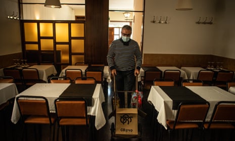 Sindo Gonzalez carries products before the midday service of the last of day of opening for the Envalira Restaurant before the introduction of new restrictions come into force in Barcelona.