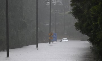 A car stranded in flood waters at Woollamia, south of Sydney, on Friday