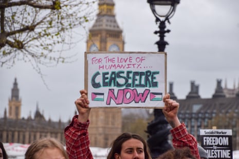 A protester holds up a sign reading 'for the love of humanity … ceasefire now' at a march in London organised by Youth Demand, a pro-Palestine and climate activist group who are demanding an arms embargo on Israel.