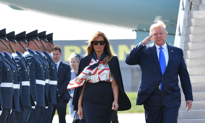President Trump and US first lady Melania Trump walk on the tarmac after disembarking Air Force One