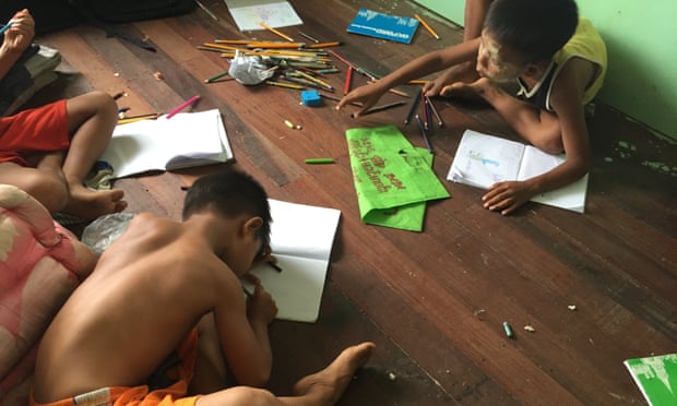 Children draw at a private orphanage in Myanmar.