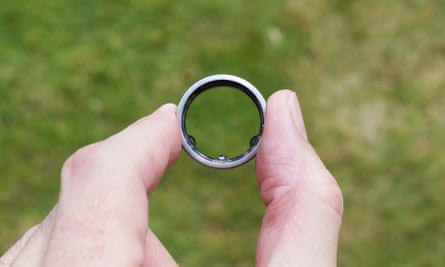 The ring being held between index finger and thumb