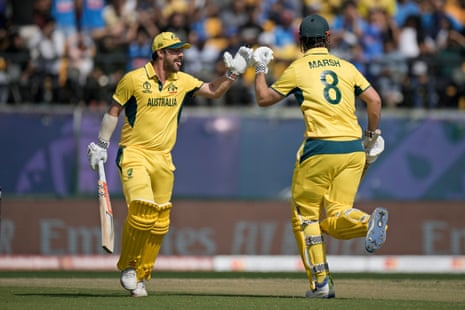 Travis Head celebrates his century with teammate Mitchell Marsh.