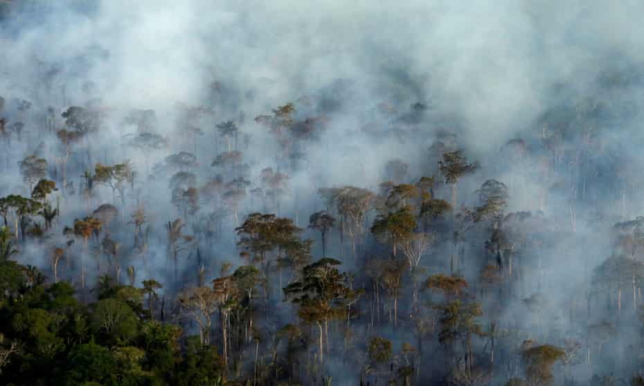 Smoke billows during a fire in an area of the Amazon rainforest