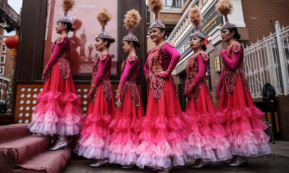 Exoticised spectacle … dancers wait to perform at the International Grand Bazaar in Urumchi