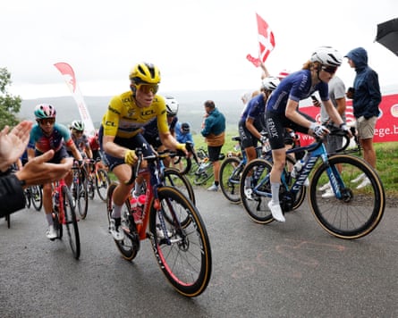 Demi Vollering on a climb in the yellow jersey.