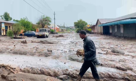 A man walks through flooded streets in Katesh, Tanzania