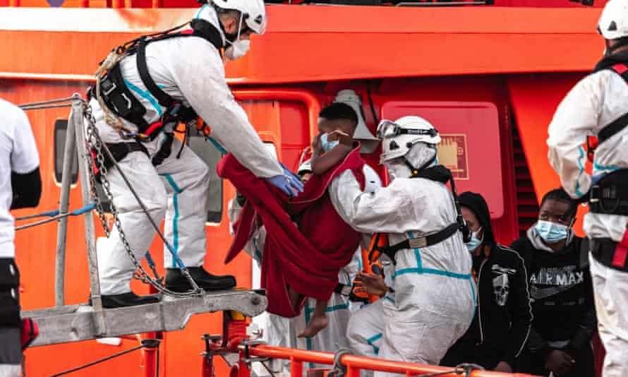 A rescued child is carried ashore at Arguineguín, on Gran Canaria, in March.