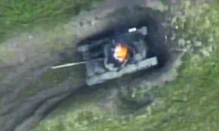 An Armenian tank, which Azerbaijani forces say they destroyed, is ablaze in Nagorno-Karabakh.