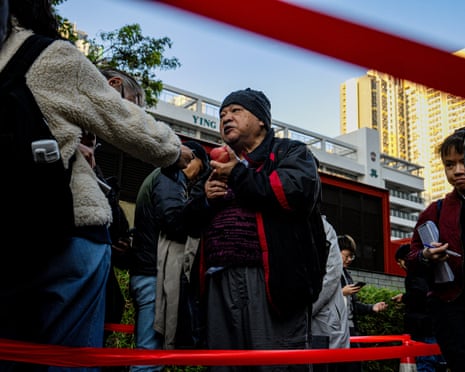Bull Tsang, a member of the now-dissolved League of Social Democrats, arrives outside the court holding Lai’s national security trial
