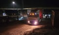 Trucks passing through border crossing at night