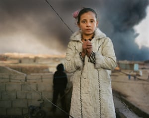Luma, 12, lives next door to a burning oil well in Qayyarah, Iraq. More than 15 wells in the town were set alight by Isis as they retreated
