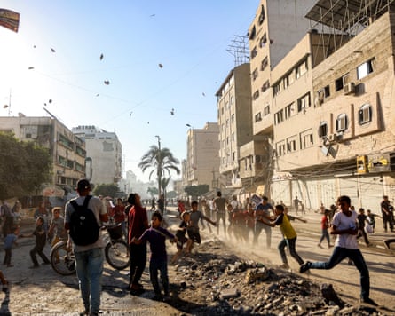People in the streets as leaflets fall from the sky