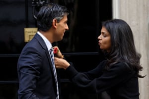 Side view of her pinning the poppy on his lapel