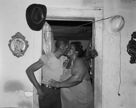 Black couple kissing in a doorway in the 1980s
